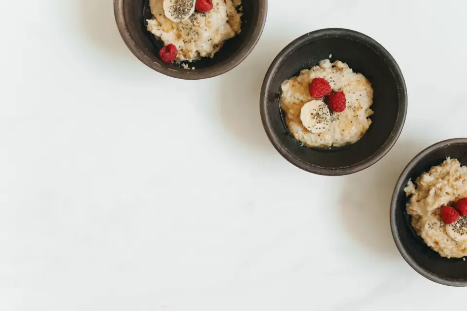Sliced banana pieces in a small bowl beside an empty dog food bowl